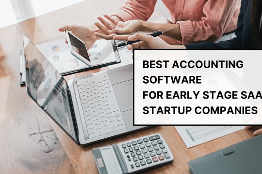Business team using laptops and calculator while discussing best accounting software for early stage SaaS startup companies