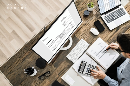 Business finance and accounting concept with hands typing on laptop keyboard, surrounded by words budget, accounting, payable, revenue, and credit