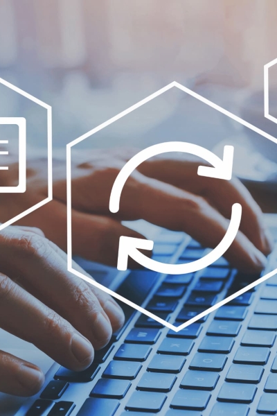 Businessman typing on laptop keyboard with digital icons of cloud sync, checklist, and devices symbolizing accounting software automation