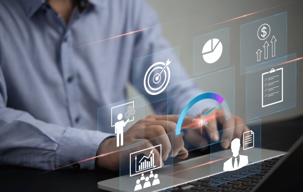 Person working on laptop with floating digital icons for business growth and productivity analytics