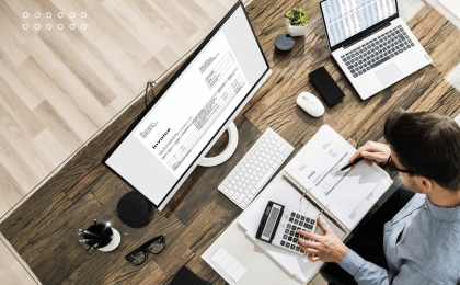 Business finance and accounting concept with hands typing on laptop keyboard, surrounded by words budget, accounting, payable, revenue, and credit