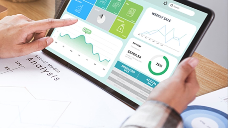 Marketing professional analyzing sales and social media data on digital automation dashboard